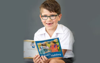 A primary school boy reads a book